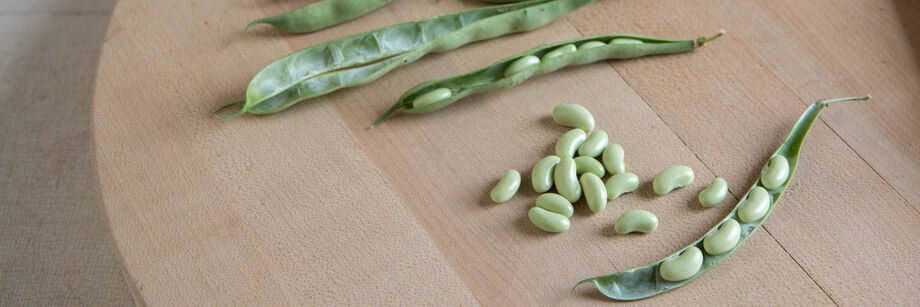 Fresh shell beans on a cutting board.